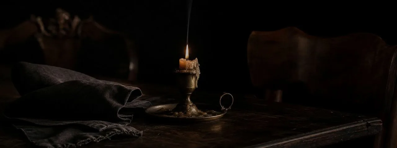 A quiet glass of wine in shadow, on why fine wine is lived rather than scored.